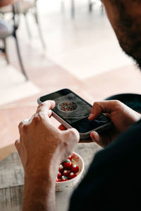 Midsection of man using mobile phone