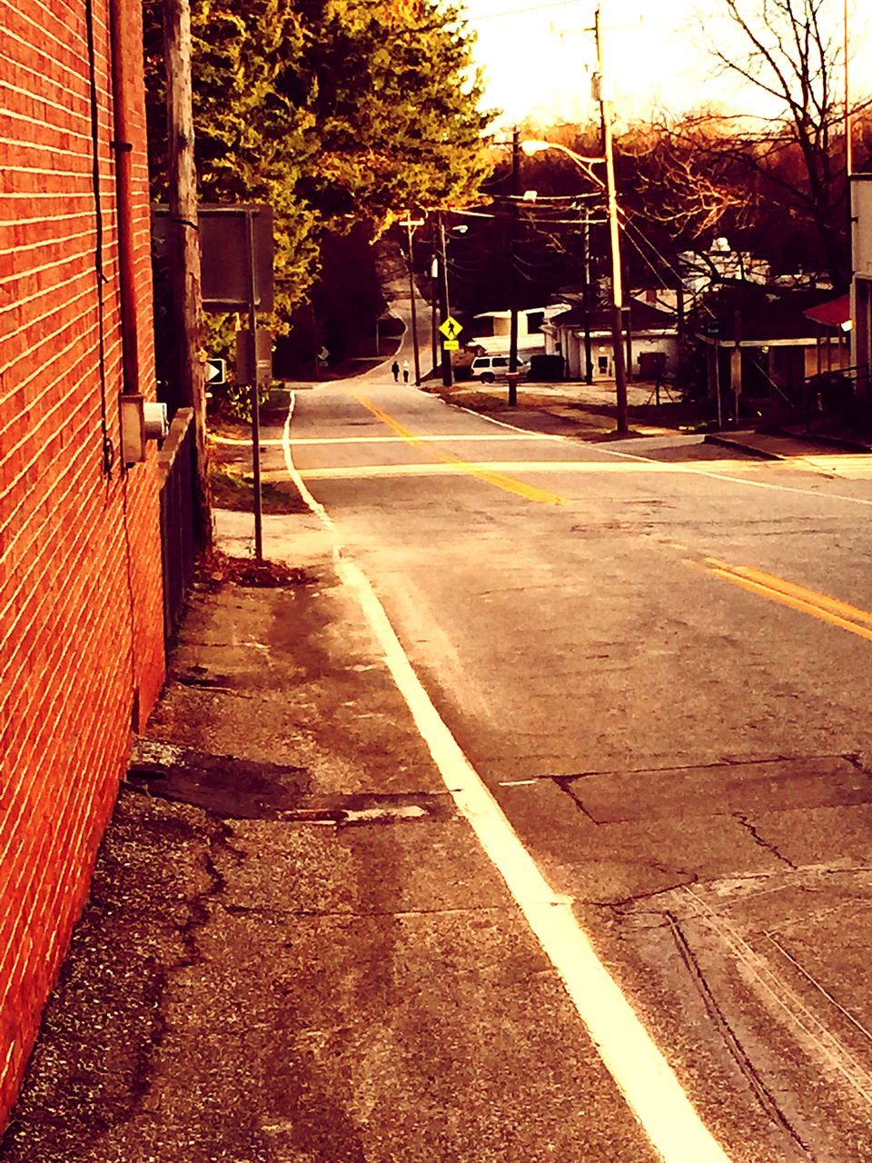 the way forward, building exterior, transportation, architecture, built structure, diminishing perspective, street, road, vanishing point, empty, tree, road marking, city, empty road, long, outdoors, no people, asphalt, cobblestone, house