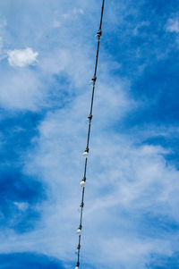 Low angle view of electricity pylon against sky