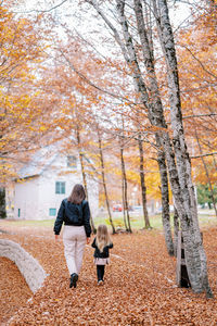 Rear view of woman with dog on field