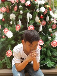 Rear view of boy on christmas tree
