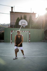 Full length of man playing basketball