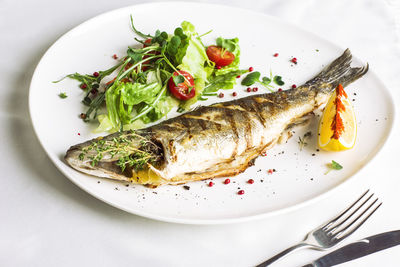 High angle view of fish served in plate on table