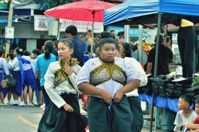 Group of people walking in market