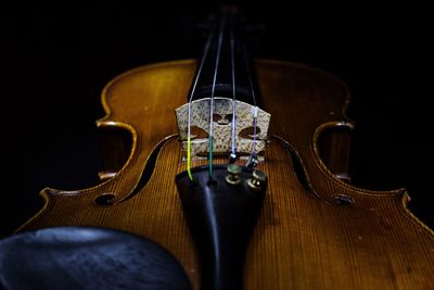 Close-up of violin against black background