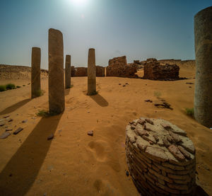 Columns and ruins of the temple complex of old dongola in the glistening light of the midday sun