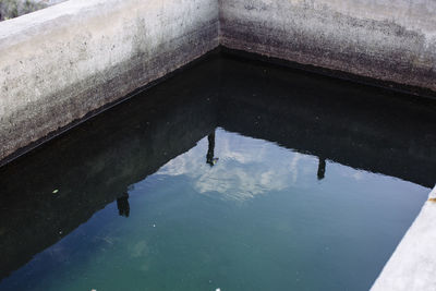 Reflection of clouds in puddle