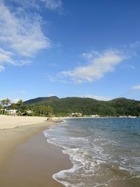 View of beach against cloudy sky