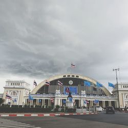 Cars on street against sky in city