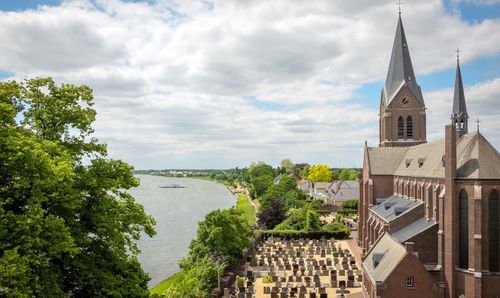 Panoramic view of buildings and trees against sky