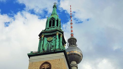 Low angle view of clock tower against cloudy sky