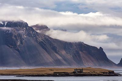 Clouds falling from mountains peaks with vast plains in the foreground