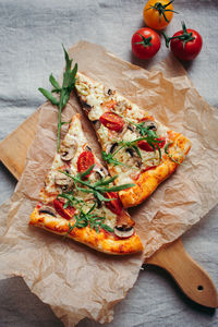 High angle view of pizza on cutting board