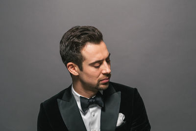 Portrait of young man against gray background