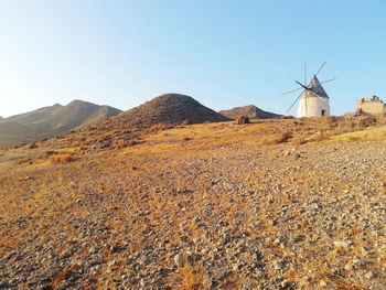 Traditional windmill on mountain against sky in cabo de gata, almería, andalucía 