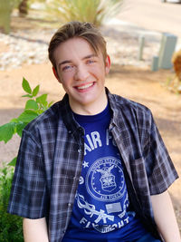 Portrait of smiling boy standing outdoors