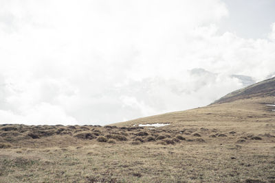 View of countryside landscape against cloudy sky