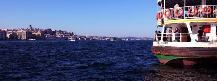 Boats in sea against clear sky