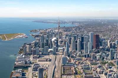 High angle view of city by sea against sky