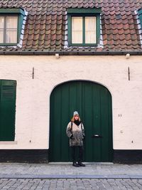 Full length of man standing against building in city