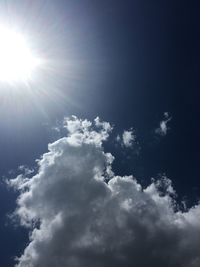 Low angle view of bright sun in sky