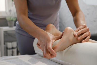 Midsection of man massaging customer