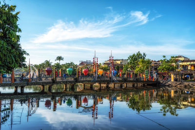 An hoi bridge and an hoi town reflection on the thu bon river in hoi an, vietnam