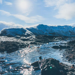 Aerial view of sea and mountains against sky