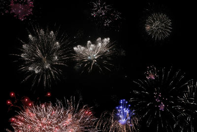 Low angle view of firework display at night