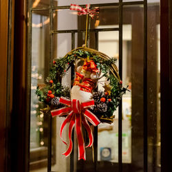 Close-up of christmas decoration hanging on window