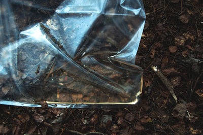 High angle view of broken glass on field