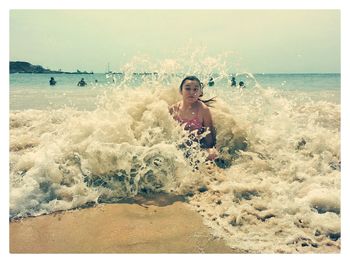 Full length of boy on beach against sky