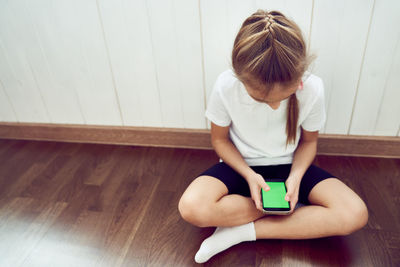 High angle view of boy using mobile phone