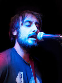 Close-up of man singing during concert