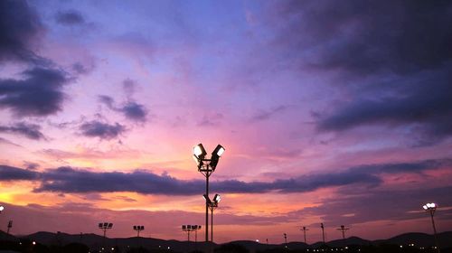 Low angle view of street light against cloudy sky