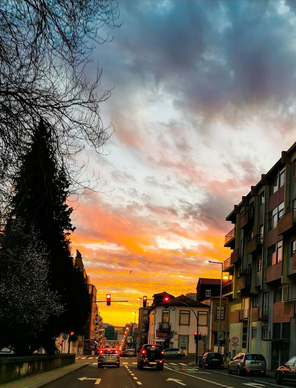 CARS ON ROAD AGAINST ORANGE SKY