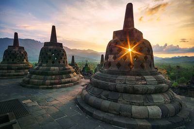 Ancient temple against sky during sunset