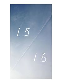 Low angle view of airplane flying against blue sky