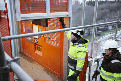 High angle view of man standing on railing