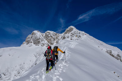 Tourists on snow covered mountain