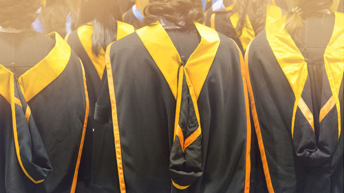 Rear view of students wearing graduation gown