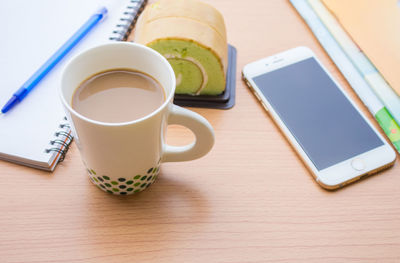 High angle view of coffee and laptop on table