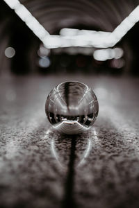 Close-up of hand holding ball on table