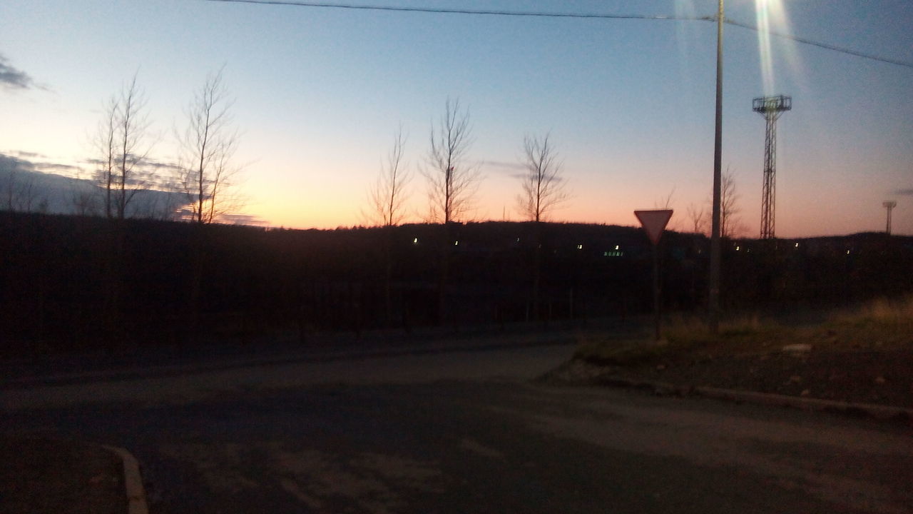 SILHOUETTE OF BARE TREES ON LANDSCAPE AT DUSK