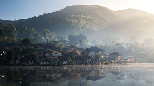 Scenic view of river with mountains in background