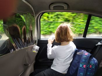 Rear view of boy in car