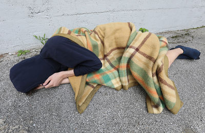 Low section of man sleeping on street