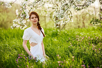 Young woman standing amidst plants