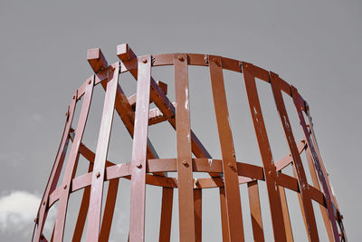 Low angle view of old metallic structure against sky