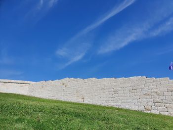 Low angle view of wall against sky